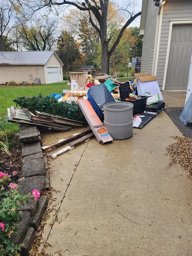 Dumpster being loaded with debris for Estate Cleanout Dumpster Rental in Bennington